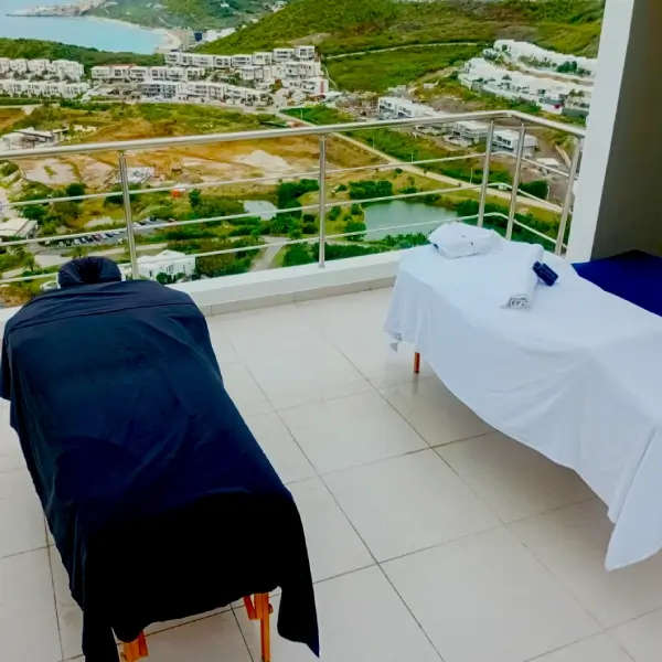 Two massage tables on a hillside balcony overlooking Beacon Hill, St. Maarten
