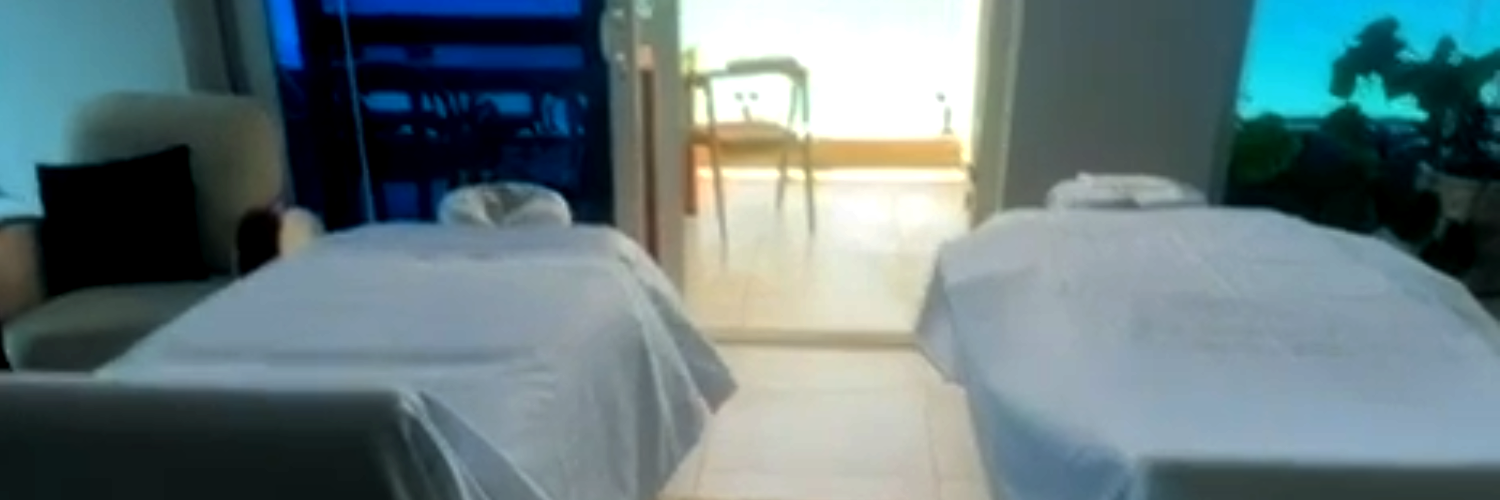 Romantic couples massage in St Maarten with two therapists performing side-by-side treatment