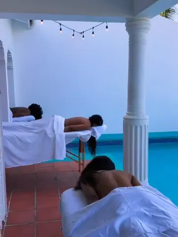 Guests receiving massages side by side next to a villa pool in St. Maarten