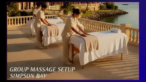 Therapist providing a relaxing beachfront massage during a private spa experience with ocean views in St Maarten.