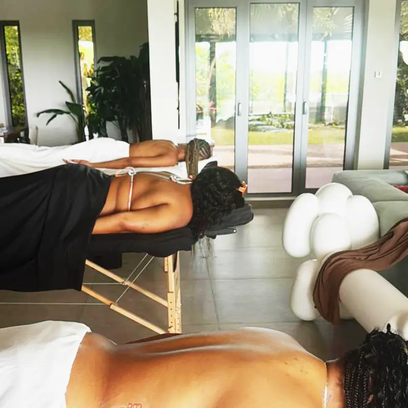 Indoor luxury spa setting with multiple clients receiving massage treatments